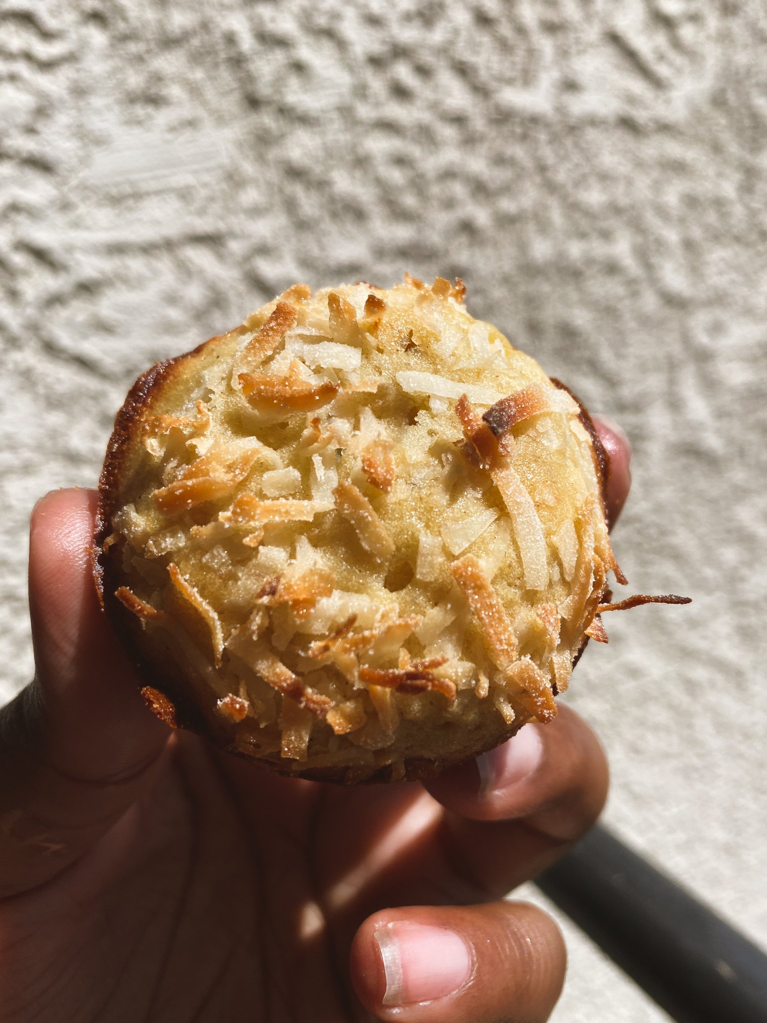 Banana Coconut Muffin photographed outside in the sunlight